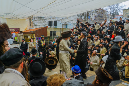 JERUSALEM, ISRAEL - FEBRUARY 25, 2016: Jewish men attend and dance, as part of a celebration of the Jewish Holyday Purim, in the ultra-orthodox neighborhood Mea Shearim, Jerusalem, Israelのeditorial素材