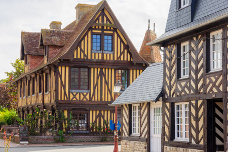 BEUVRON-EN-AUGE, FRANCE - SEPTEMBER 18, 2012: Half-timbered houses and local businesses, in Beuvron-en-Auge, Normandy, France. It was awarded as the most beautiful villages of Franceのeditorial素材
