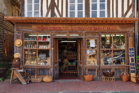 BEUVRON-EN-AUGE, FRANCE - SEPTEMBER 18, 2012: Half-timbered houses and local businesses, in Beuvron-en-Auge, Normandy, France. It was awarded as the most beautiful villages of Franceのeditorial素材