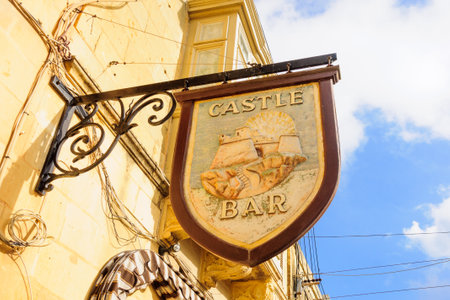 VICTORIA, MALTA - APRIL 11, 2012: An alley with typical bar signs, in Victoria, Gozo Island, Maltaのeditorial素材