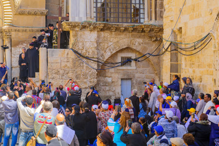 JERUSALEM, ISRAEL - APRIL 29, 2016: An Orthodox Good Friday scene in the yard of the church of the Holy Sepulcher, with the Greek Orthodox Patriarchate and pilgrims. The old city of Jerusalem, Israelのeditorial素材