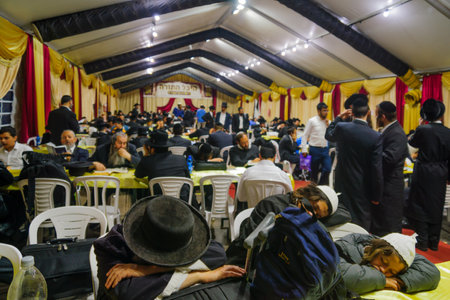 MERON, ISRAEL - MAY 26, 2016: A crowd of orthodox Jews attend, read and nap at the annual hillulah of Rabbi Shimon Bar Yochai, in Meron, Israel, on Lag BaOmer Holidayのeditorial素材