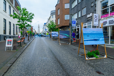 REYKJAVIK, ICELAND - JUNE 10, 2016: View of the Hallgrimskirkja church and Skolavordustigur Street, with photographs display, locals and visitors, in Reykjavik, Icelandのeditorial素材