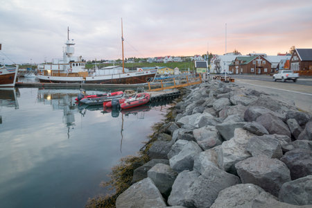 HUSAVIK, ICELAND - JUNE 15, 2016: Sunset view of the fishing harbor of Husavik, northeast Icelandのeditorial素材