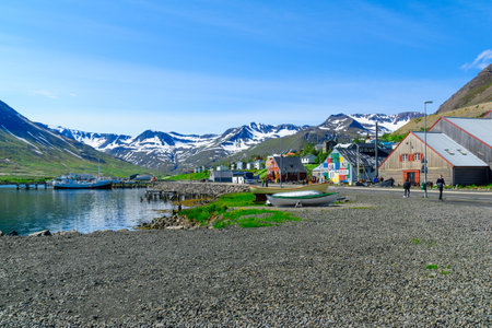 SIGLUFJORDUR, ICELAND - JUNE 18, 2016: View of the fishing port and town, with locals and tourists, in Siglufjordur, Northern Icelandのeditorial素材