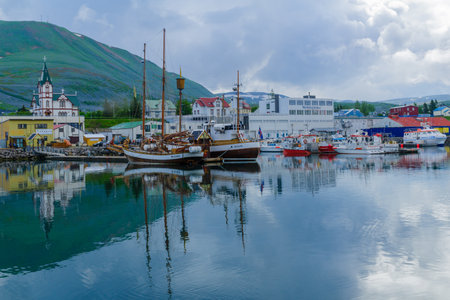 HUSAVIK, ICELAND - JUNE 17, 2016: View of the fishing harbor and the church of Husavik, northeast Icelandのeditorial素材
