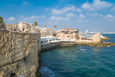ACRE, ISRAEL - AUGUST 03, 2016: Scene of the sea walls, with local businesses, locals and tourists,...