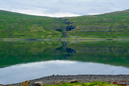 View of coastline and landscape along the Isafjordur fjord, in the west fjords region, Icelandの写真素材