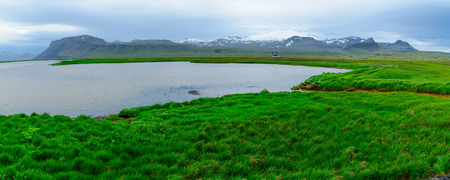 Panoramic landscape and the Snaefellsjokull volcano, in the Snaefellsnes peninsula, west Icelandの写真素材
