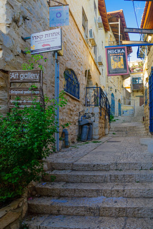 SAFED, ISRAEL - SEPTEMBER 14, 2016: An ally in the Jewish quarter of the old city, with various business signs, in Safed (Tzfat), Israelのeditorial素材