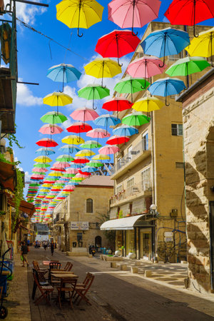 JERUSALEM, ISRAEL - SEPTEMBER 23, 2016: Scene of Yoel Moshe Solomon Street, decorated with colorful umbrellas, with locals and visitors, in the historic Nachalat Shiva district, Jerusalem, Israelのeditorial素材