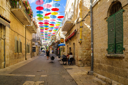 JERUSALEM, ISRAEL - SEPTEMBER 23, 2016: Scene of Yoel Moshe Solomon Street, decorated with colorful umbrellas, with locals and visitors, in the historic Nachalat Shiva district, Jerusalem, Israelのeditorial素材