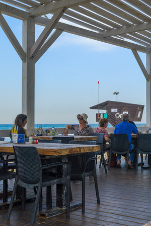 HAIFA, ISRAEL - OCTOBER 27, 2016: Beach promenade scene with workers and visitors, in Haifa, Israelのeditorial素材