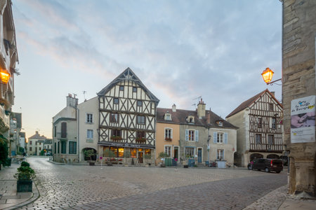 NOYERS-SUR-SEREIN, FRANCE - OCTOBER 11, 2016: Sunset view of the main square (place de hotel de ville), with half-timbered houses, in the medieval village Noyers-sur-Serein, Burgundy, Franceのeditorial素材