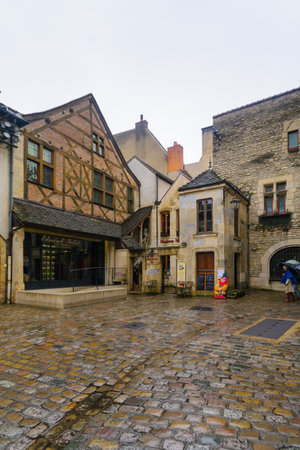 DIJON, FRANCE - OCTOBER 14, 2016: Street scene with typical old houses, locals and visitors, in Dijon, Burgundy, Franceのeditorial素材