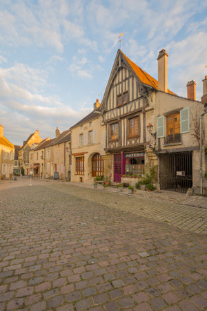 NOYERS-SUR-SEREIN, FRANCE - OCTOBER 11, 2016: Sunset view of the main square (place de hotel de ville), with half-timbered houses, in the medieval village Noyers-sur-Serein, Burgundy, Franceのeditorial素材