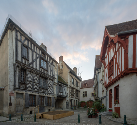 Sunset view of a square (place de la petite etape aux vins), with half-timbered houses, in the medieval village Noyers-sur-Serein, Burgundy, Franceの写真素材
