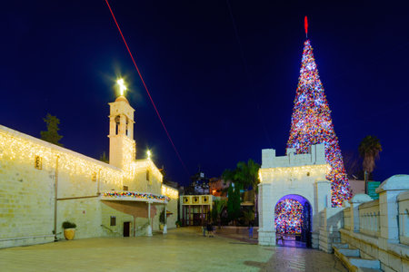 NAZARETH, ISRAEL - DECEMBER 20, 2016: Christmas scene of Mary Well square, with the Greek Orthodox Church of the Annunciation, a Christmas tree, locals and tourists, in Nazareth, Israelのeditorial素材