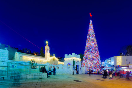 NAZARETH, ISRAEL - DECEMBER 20, 2016: Christmas scene of Mary Well square, with the Greek Orthodox Church of the Annunciation, a Christmas tree, locals and tourists, in Nazareth, Israelのeditorial素材