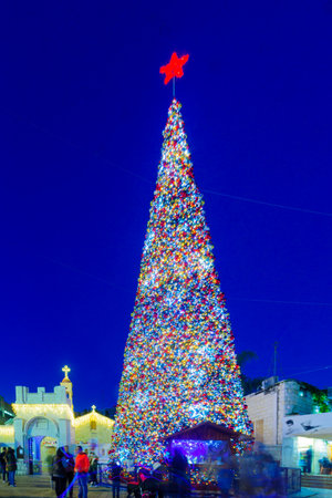 NAZARETH, ISRAEL - DECEMBER 20, 2016: Christmas scene of Mary Well square, with the Greek Orthodox Church of the Annunciation, a Christmas tree, locals and tourists, in Nazareth, Israelのeditorial素材