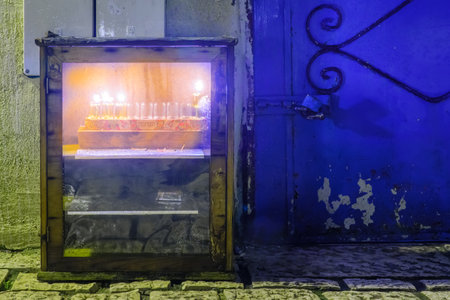 SAFED, ISRAEL - DECEMBER 26, 2016: Traditional Menorah (Hanukkah Lamp) with olive oil candles, in the Jewish quarter, in Safed (Tzfat), Israel. Text is: Hanukkahのeditorial素材