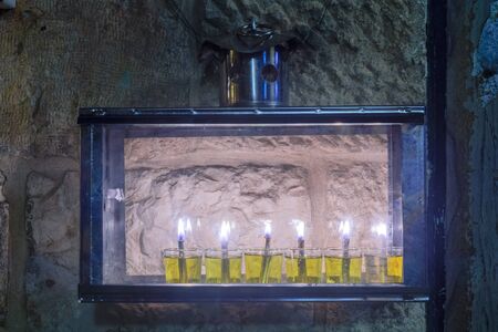 Traditional Menorah (Hanukkah Lamp) with olive oil candles, in the Jewish quarter, Jerusalem Old City, Israelの写真素材
