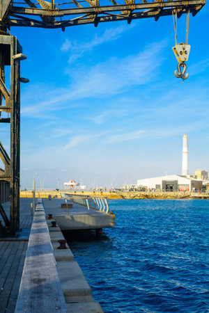 TEL-AVIV, ISRAEL - JANUARY 12, 2017: Scene with a restored crane, a carrousel, a commercial area, the Reading power station chimney, and visitors, in Tel-Aviv Port, Tel-Aviv, Israelのeditorial素材