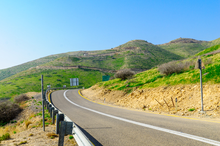 Road, landscape, and driving distance sign, in the southern part of the Golan Heights, Northern Israelの写真素材