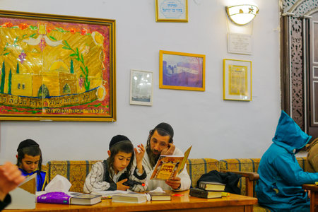 SAFED, ISRAEL - MAR 11, 2017: Traditional Purim (Jewish Holiday) in the old Abuhav synagogue with prayers, some in costumes, attend a reading of the megillah (Scroll of Esther). Safed (Tzfat), Israelのeditorial素材