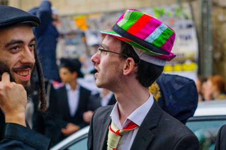 JERUSALEM, ISRAEL - MARCH 13, 2017: Ultra-orthodox Jewish men, some in costumes, as part of a celebration of the Jewish Holyday Purim, in the Mea Shearim neighborhood, Jerusalem, Israelのeditorial素材