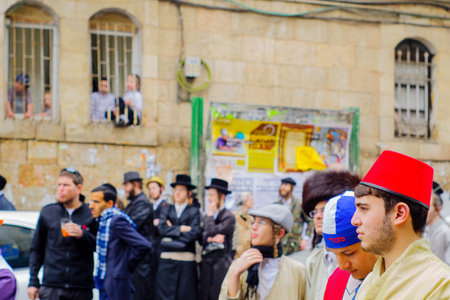JERUSALEM, ISRAEL - MARCH 13, 2017: Ultra-orthodox Jewish men, some in costumes, as part of a celebration of the Jewish Holyday Purim, in the Mea Shearim neighborhood, Jerusalem, Israelのeditorial素材