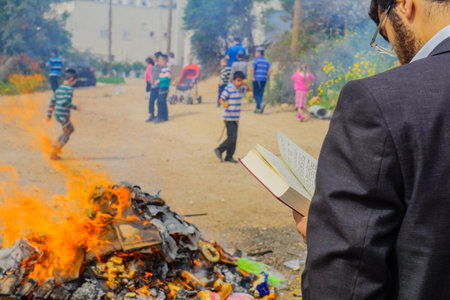 HAIFA, ISRAEL - APRIL 10, 2017: Jewish people perform Biur (burning) Chametz (leavened foods), and say blessing, in Haifa, Israel. This is part of the Passover holiday traditionsのeditorial素材