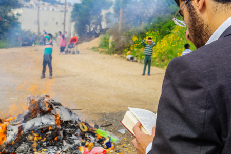 HAIFA, ISRAEL - APRIL 10, 2017: Jewish people perform Biur (burning) Chametz (leavened foods), and say blessing, in Haifa, Israel. This is part of the Passover holiday traditionsのeditorial素材