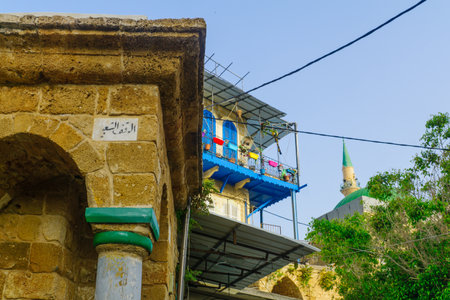 ACRE, ISRAEL - APRIL 27, 2017: An old building, typical balcony and the Ahmed el-Jazzar Mosque, in the old city of Acre (Akko), Israelのeditorial素材