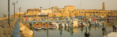 ACRE, ISRAEL - APRIL 27, 2017: Panoramic view of the fishing harbor, with boats, yachts and nearby monuments, in the old city of Acre (Akko), Israel. Acre was a major harbor city for many centuriesのeditorial素材