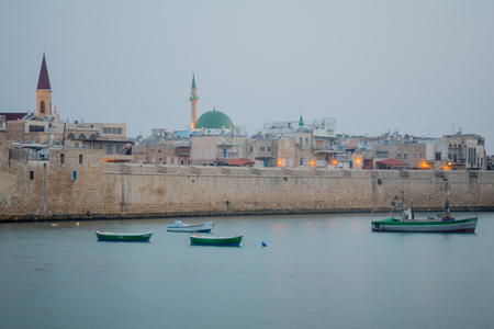 Fishing boats, and the old sea wall in the old city of Acre (Akko), Israelの写真素材