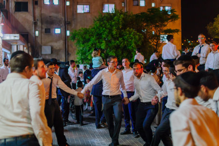 HAIFA, ISRAEL - MAY 13, 2017: A group of ultra-orthodox Jews dance, as part of the Lag BaOmer holiday celebration, in Haifa, Israelのeditorial素材