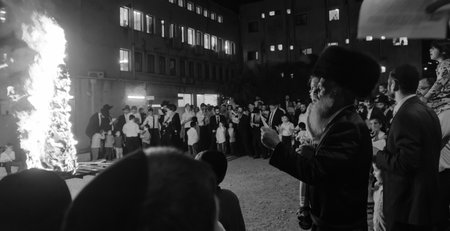 HAIFA, ISRAEL - MAY 13, 2017: A crowd of ultra-orthodox Jews gather around a fire, as part of the Lag BaOmer holiday celebration, in Haifa, Israelのeditorial素材
