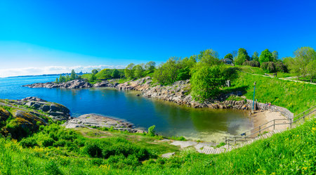 HELSINKI, FINLAND - JUNE 15, 2017: View of a bay and a beach in Suomenlinna Island, with bathers, in Helsinki, Finlandのeditorial素材