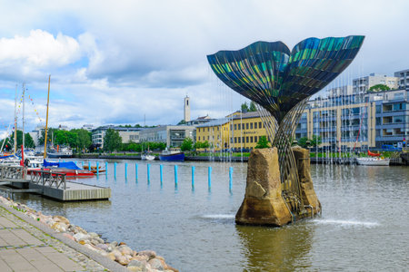 TURKU, FINLAND - JUNE 23, 2017: View of the Harmonia fountain sculpture and the Aura river, with locals and visitors, in Turku, Finlandのeditorial素材