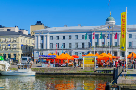 HELSINKI, FINLAND - JUNE 15, 2017: Scene of the south harbor, with the market, the city hall, the Lutheran Cathedral in the background, locals and visitors, in Helsinki, Finlandのeditorial素材