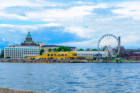HELSINKI, FINLAND - JUNE 16, 2017: Scene of the south harbor, with the Russian Orthodox Uspenski Cathedral, the SkyWheel, locals and visitors, in Helsinki, Finlandのeditorial素材