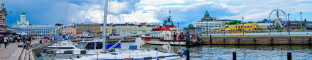 HELSINKI, FINLAND - JUNE 16, 2017: Panoramic view of the south harbor, with the Lutheran Cathedral, the Russian Orthodox Uspenski Cathedral, the SkyWheel, locals and visitors, in Helsinki, Finlandのeditorial素材
