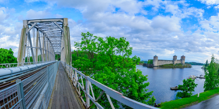 Panoramic view of a train bridge and the Olavinlinna castle in Savonlinna, Finland. It is a 15th-century three-tower castleの写真素材