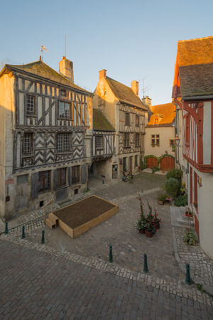 View of a square (place de la petite etape aux vins), with half-timbered houses, in the medieval village Noyers-sur-Serein, Burgundy, Franceの写真素材