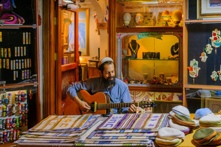 SAFED, ISRAEL - AUGUST 23, 2017: Scene of the Klezmer Festival, with street musician playing, in Safed (Tzfat), Israel. Its the 30th annual traditional Jewish festival in the public streets of Safedのeditorial素材