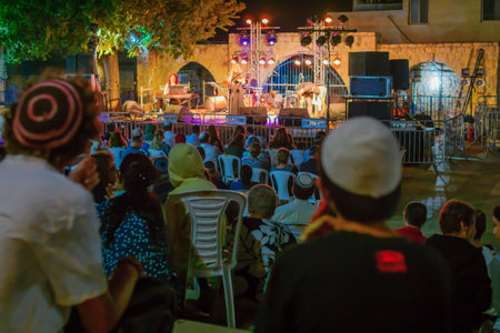 SAFED, ISRAEL - AUGUST 23, 2017: Scene of the Klezmer Festival, with crowd watching musicians in Safed (Tzfat), Israel. Its the 30th annual traditional Jewish festival in the public streets of Safedのeditorial素材