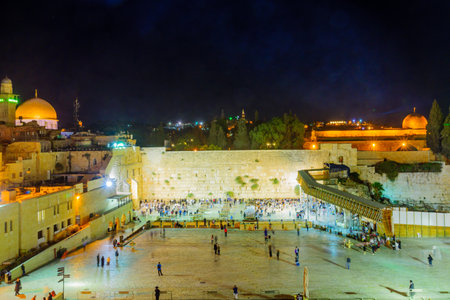 JERUSALEM, ISRAEL - SEPTEMBER 06, 2017:  Night scene of the Western Wall with Jewish prayers, and the Dome of the Rock in the background, in Jerusalem, Israelのeditorial素材