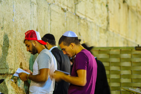 JERUSALEM, ISRAEL - SEPTEMBER 06, 2017:  Night scene of the Western Wall with various Jewish prayers, in Jerusalem, Israel. This is the holiest place in Jewish traditionのeditorial素材
