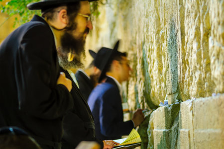 JERUSALEM, ISRAEL - SEPTEMBER 06, 2017:  Night scene of the Western Wall with various Jewish...